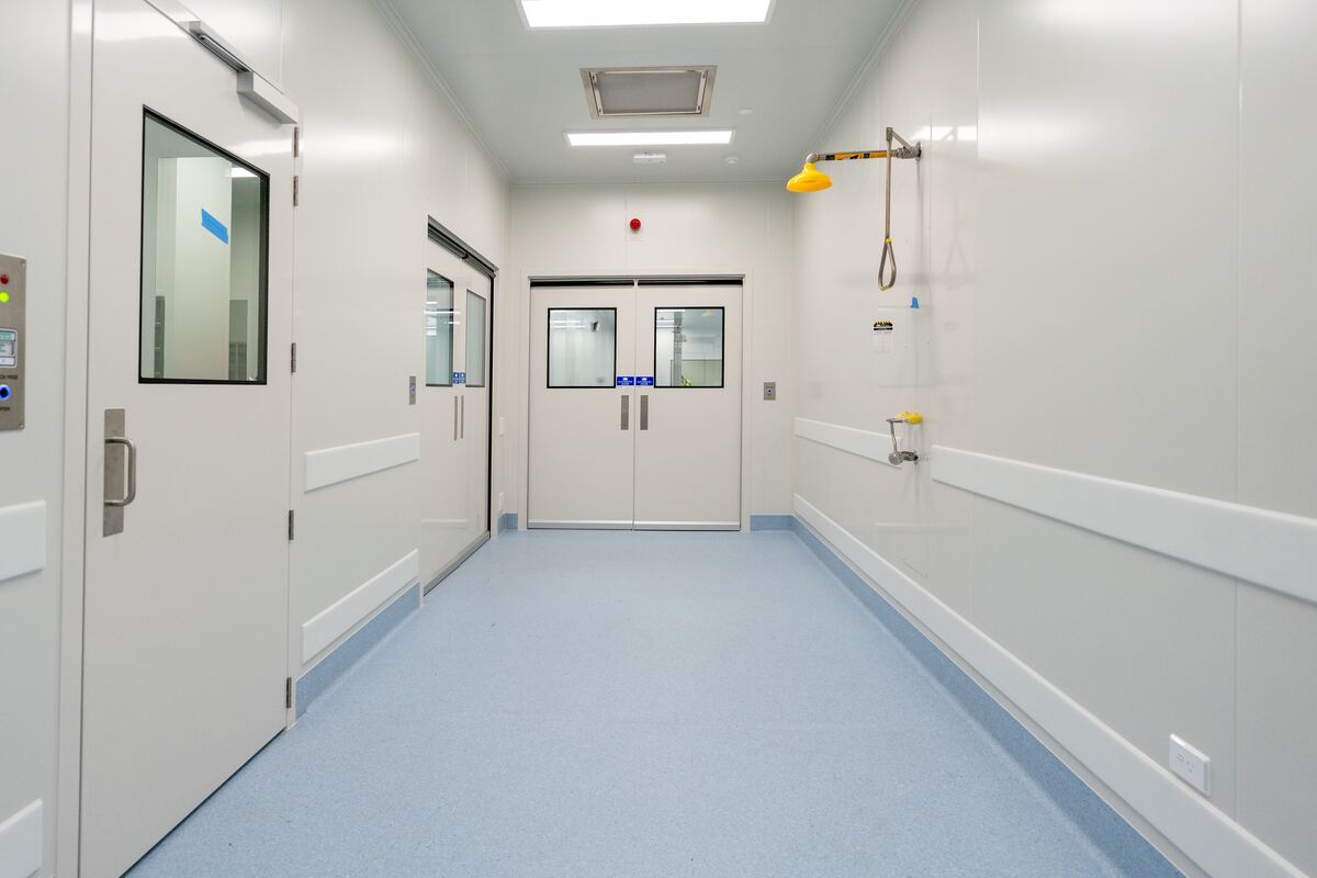 Coved sheet vinyl in a controlled-environment corridor at PolyNovo, installed by JA Floors for BIO Construct Services