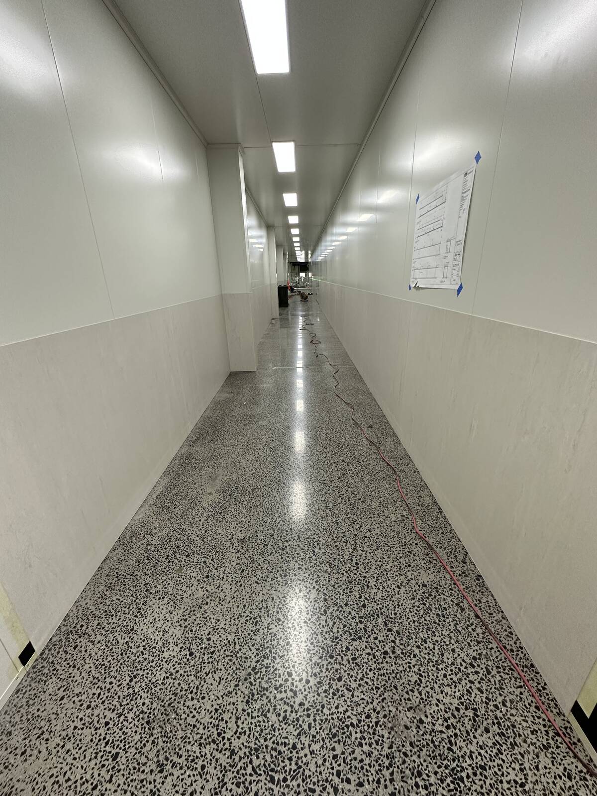 Polished concrete corridor with wall protection panels on the Paragon Care project, by JA Floors
