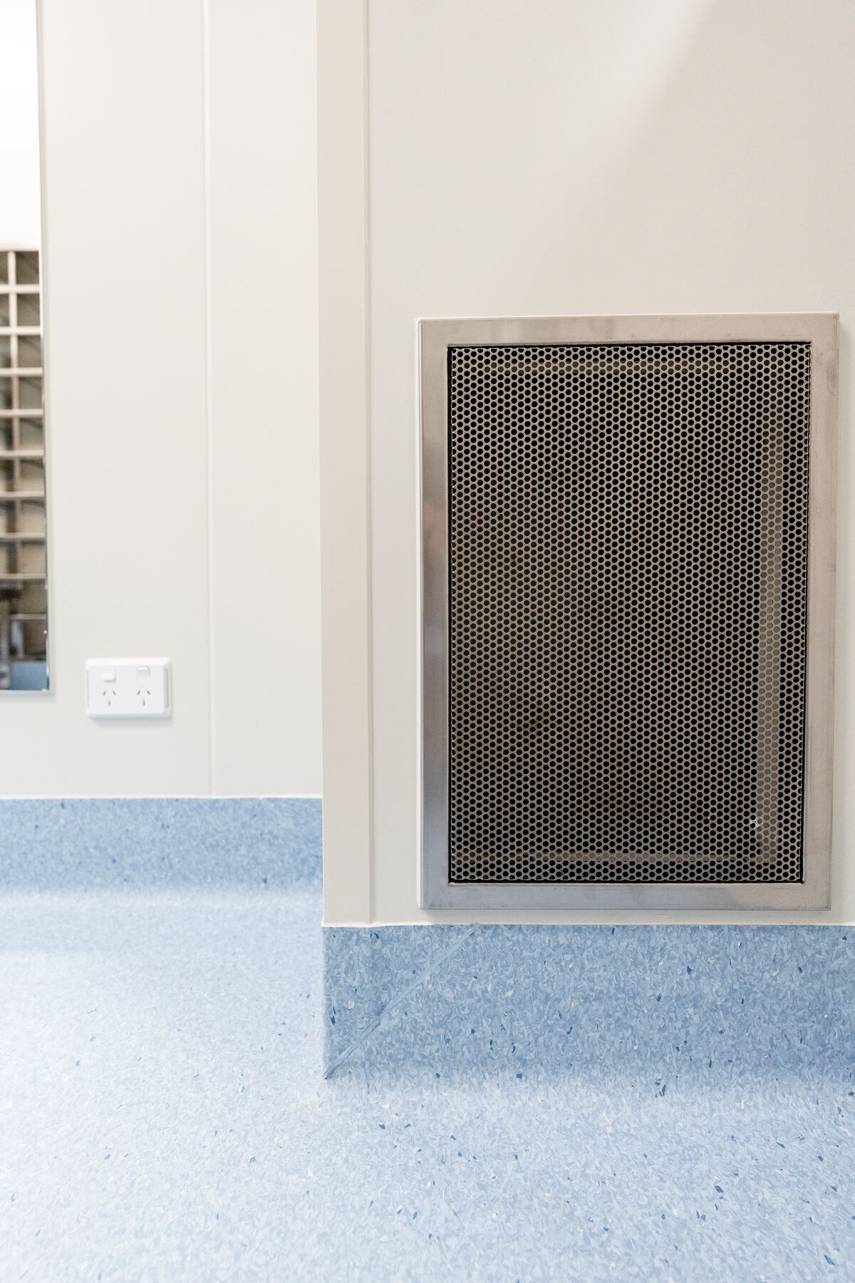 Coved sheet vinyl meeting a wall panel in a controlled environment at PolyNovo, installed by JA Floors
